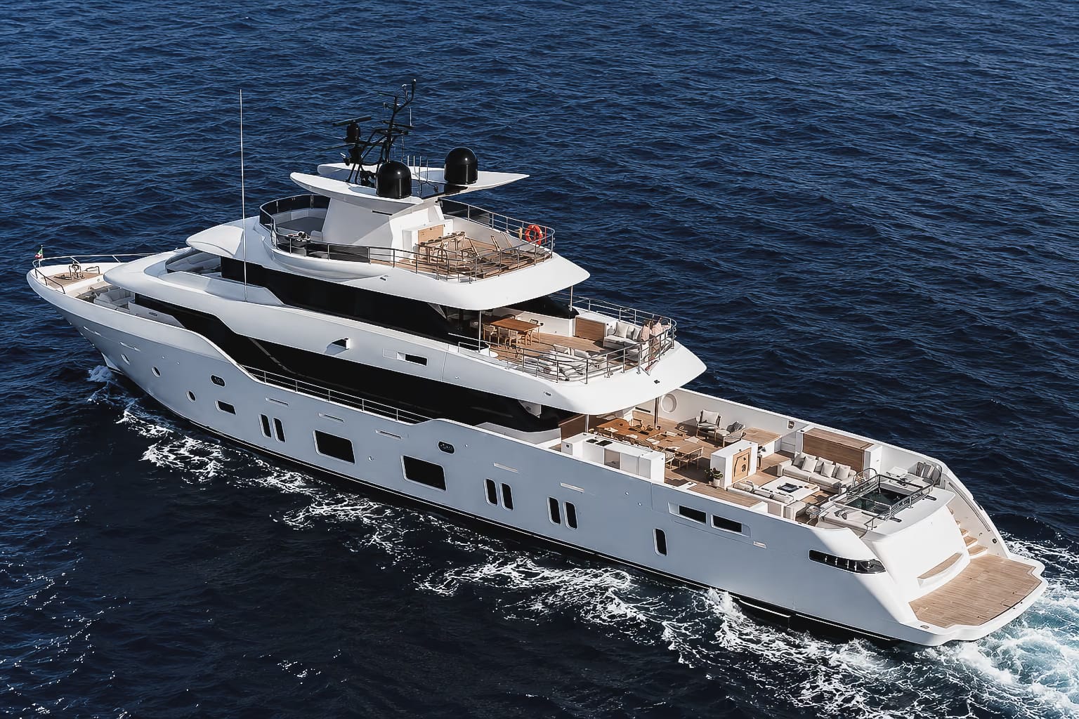 Aerial view of the Canados Oceanic 143 tri-deck superyacht under way on deep blue water